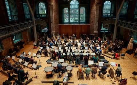 An orchestra rehearsing in the Jerwood Hall, LSO St Luke's