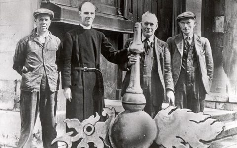 The vicar and parishioners of St Luke's Church with the weathervane, before deconsecration