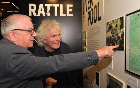 Sir Simon Rattle looks at an exhibition about him